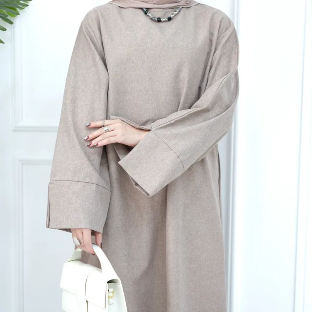 Shop the Modest Plain Abaya in Dusty Sandstone at Hikmah Boutique. Earthy tone, modest fit, and long sleeves. Available in all sizes at reasonable prices.