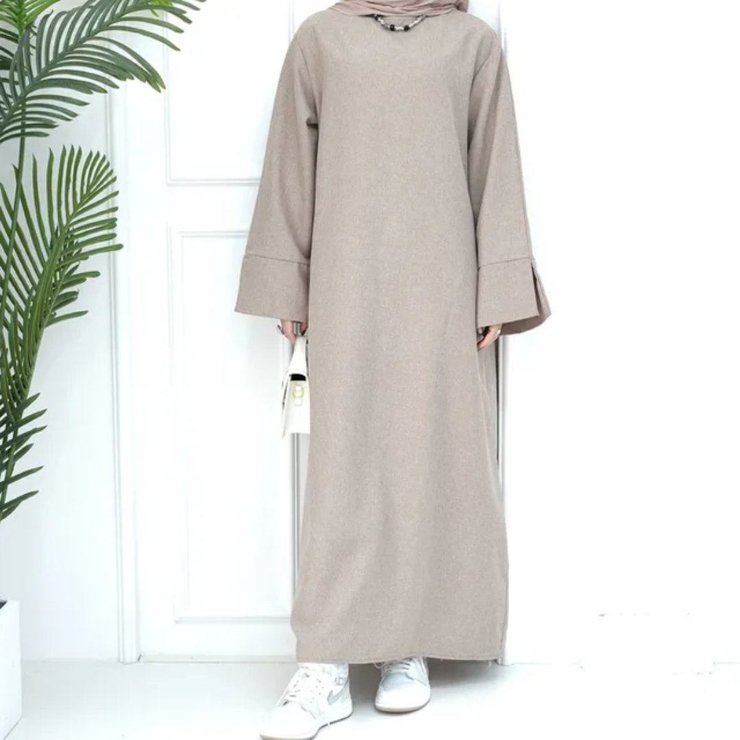 Shop the Modest Plain Abaya in Dusty Sandstone at Hikmah Boutique. Earthy tone, modest fit, and long sleeves. Available in all sizes at reasonable prices.