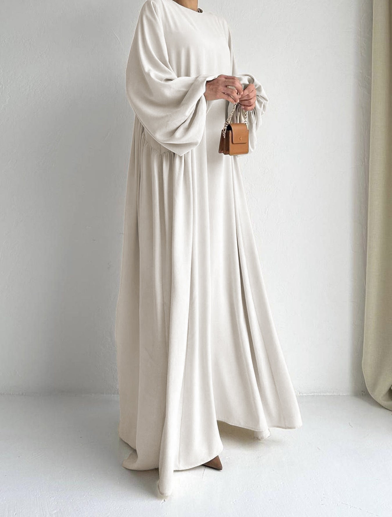 Stay cool in our Cream Beige Modest Summer Abaya, featuring a silky feel, loose fit, and cuff sleeves. Perfect for warm weather. Shop online or in-store in Sydney.