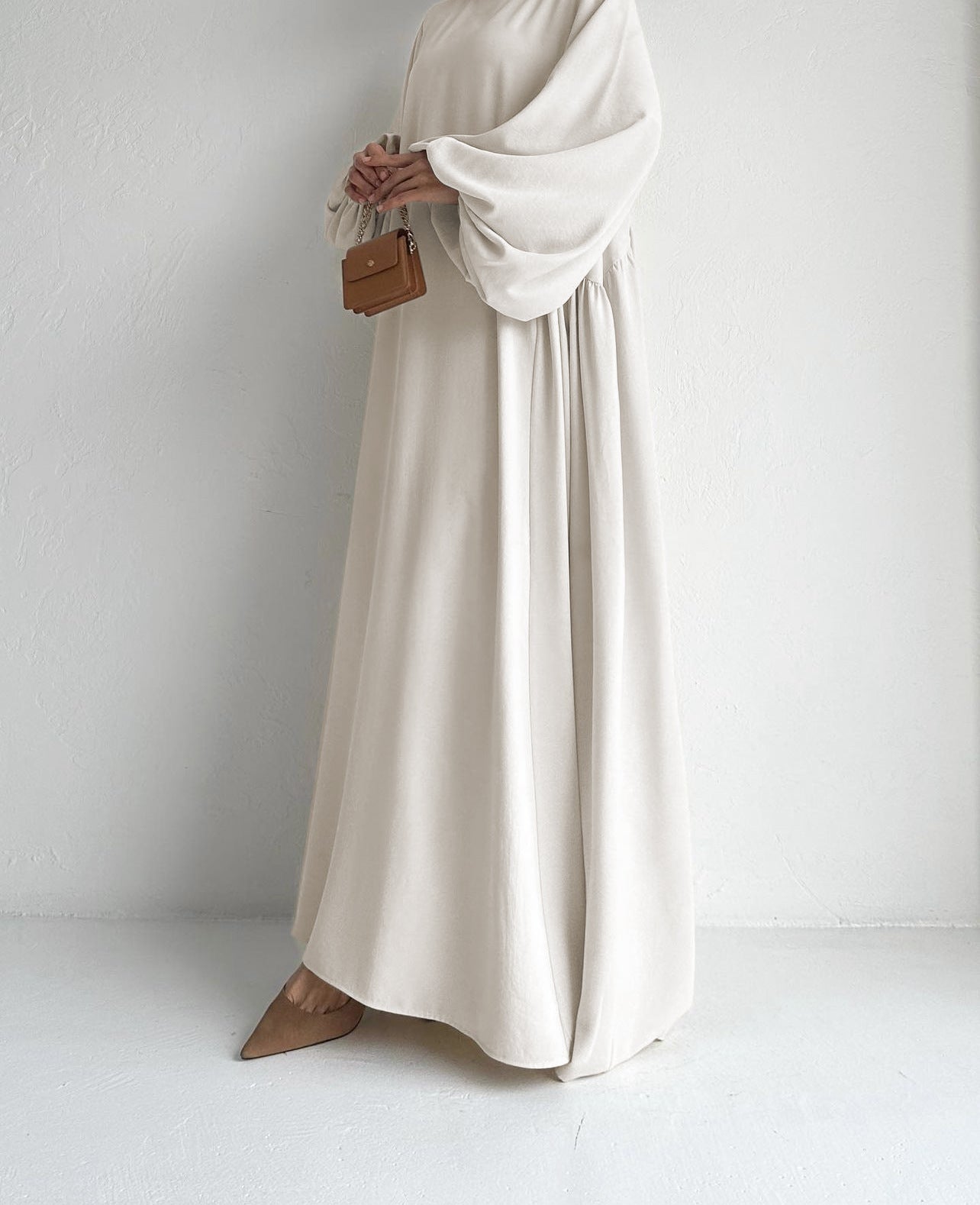 Stay cool in our Cream Beige Modest Summer Abaya, featuring a silky feel, loose fit, and cuff sleeves. Perfect for warm weather. Shop online or in-store in Sydney.