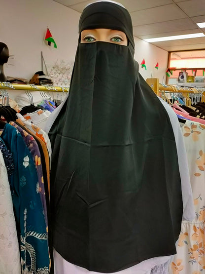 Discover the timeless modesty and elegance of the Hikmah Boutique Single Layer Niqab in Black. Crafted with care and attention to detail, this niqab embodies the essence of modest clothing, offering both coverage and comfort in a classic design.