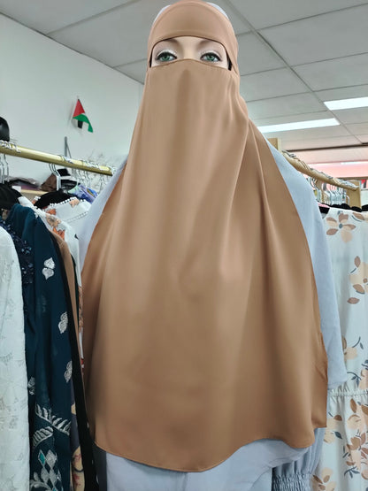 Discover the understated allure of the Hikmah Boutique Single Layer Niqab in Dusty Brown. This finely tailored niqab embodies the essence of modest clothing, offering both coverage and comfort in a design that exudes elegance. 