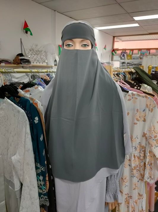 Embrace the subtle sophistication of the Hikmah Boutique Single Layer Niqab in Grey. This meticulously crafted niqab epitomizes modest clothing, offering both coverage and comfort in a design that exudes elegance.