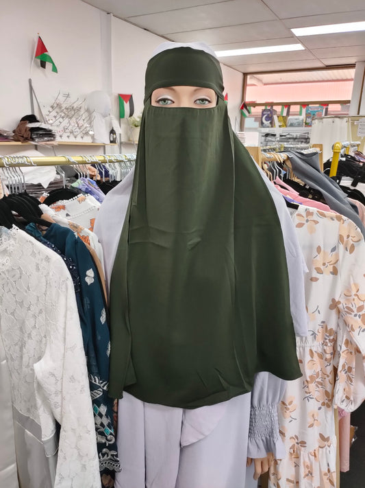 Embrace the timeless elegance of the Hikmah Boutique Single Layer Niqab in Olive Green. Crafted with care from premium materials, this niqab combines coverage and comfort in a design that exudes sophistication in Modest Clothing.