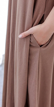 Introducing the Khaki Abaya Dress, a stunning addition to your wardrobe that is perfect for any occasion. Made with high-quality fabric, this abaya is durable, comfortable, and designed to last. Featuring a beautiful khaki color, this abaya is a classic choice that will never go out of style. The crew neck adds a touch of elegance.