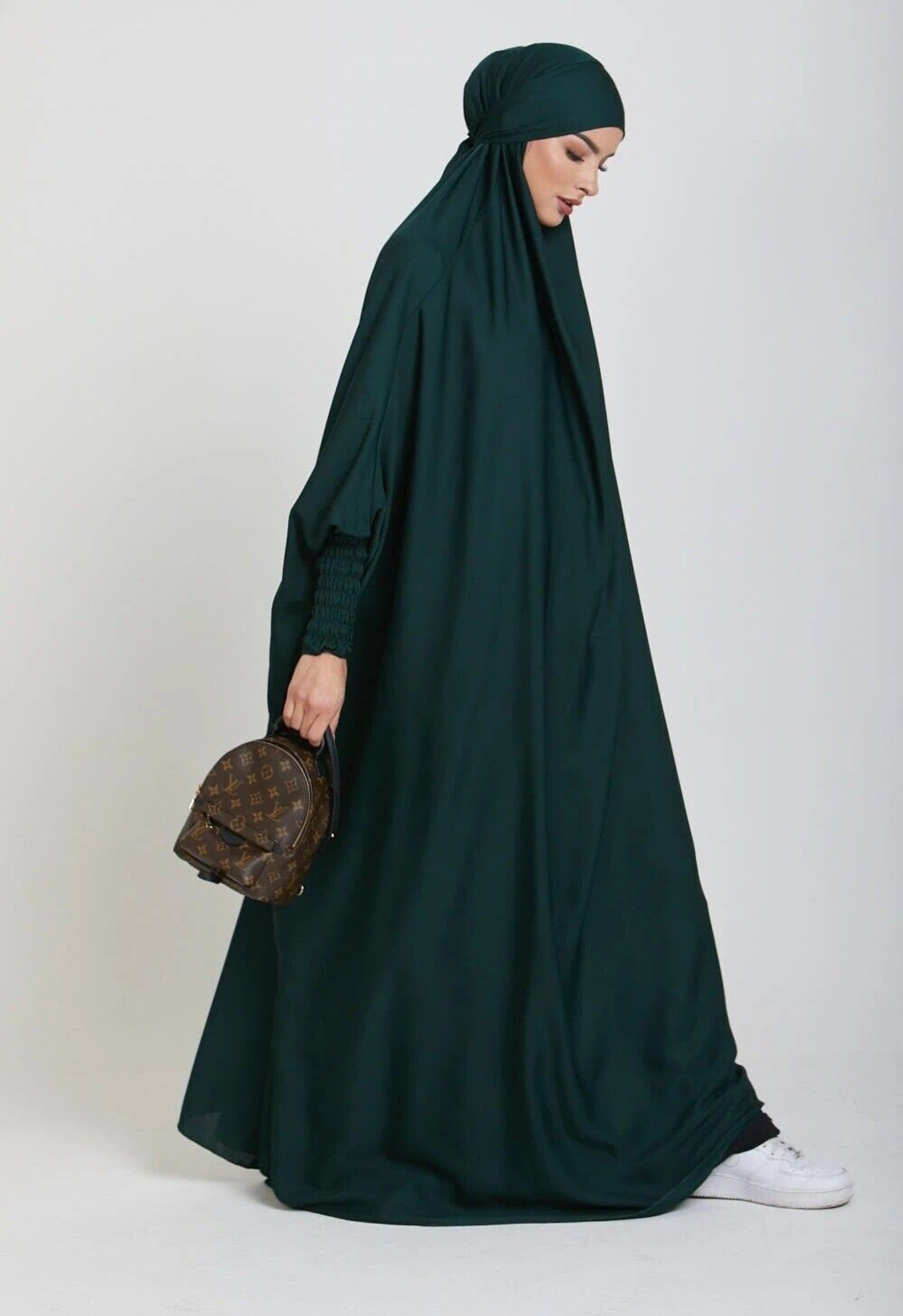 Adorn yourself in the lush beauty of our Emerald Green One Piece Tie-Up Jilbab. This exclusive Islamic garment seamlessly blends modesty with contemporary allure, offering a captivating fusion of grace and comfort for your sacred moments of devotion.