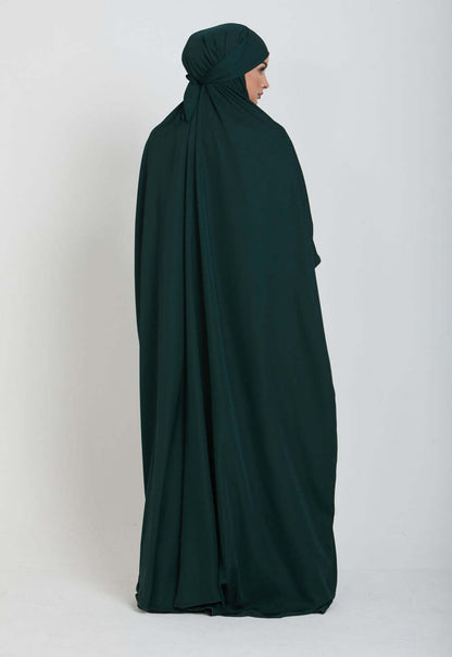 Adorn yourself in the lush beauty of our Emerald Green One Piece Tie-Up Jilbab. This exclusive Islamic garment seamlessly blends modesty with contemporary allure, offering a captivating fusion of grace and comfort for your sacred moments of devotion.
