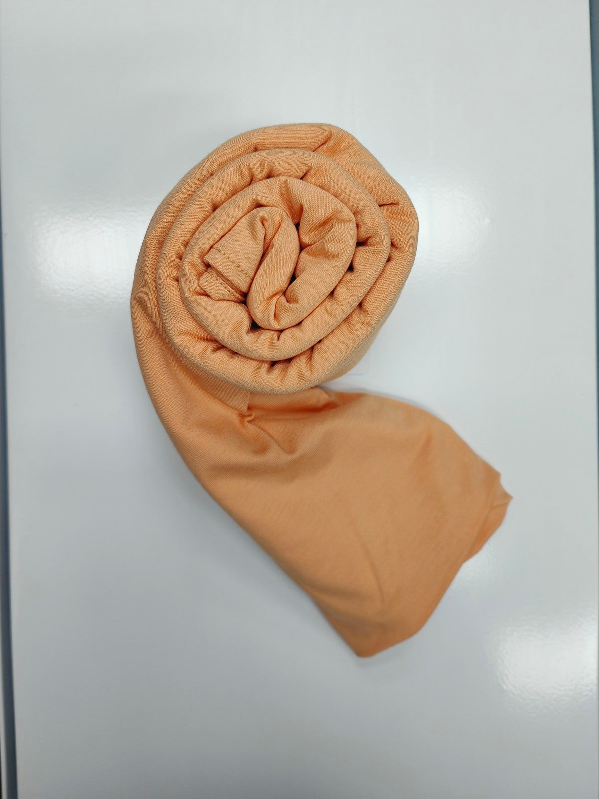 Discover the pinnacle of elegance and comfort with our Tangerine Pure Bamboo Hijab, exclusively offered by Hikmah Boutique. This hijab seamlessly merges style, breathability, and eco-friendliness, making it the ideal choice for any occasion. Stay cool and confident with Hikmah Boutique's Premium Quality Hijabs.