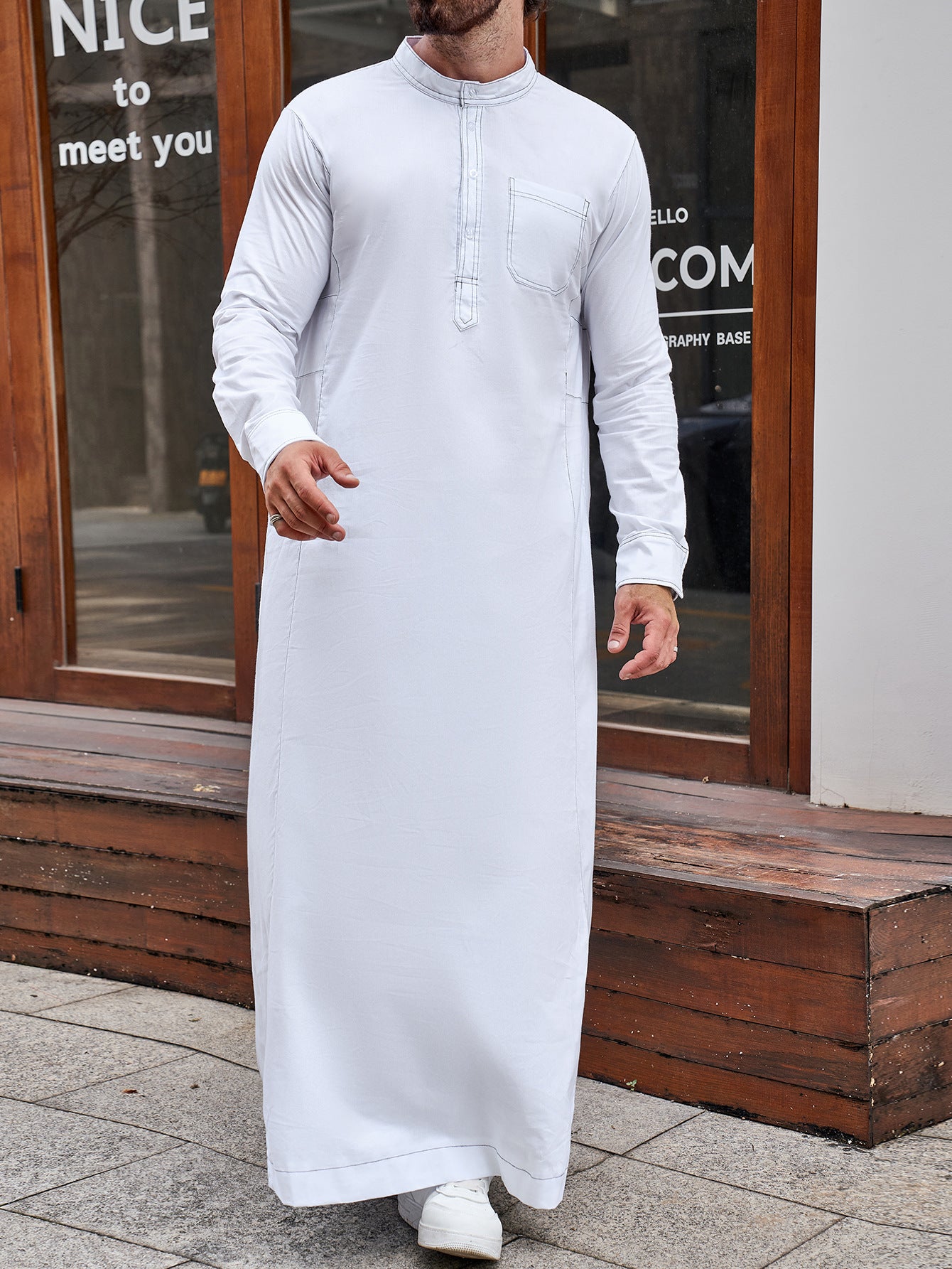 Pure Cotton Saudi White Thobe. This authentic thobe is made from pure cotton fabric and features a standard half collar, long sleeves, chest buttons, and pockets. Shop now at Hikmah Boutique Australia.