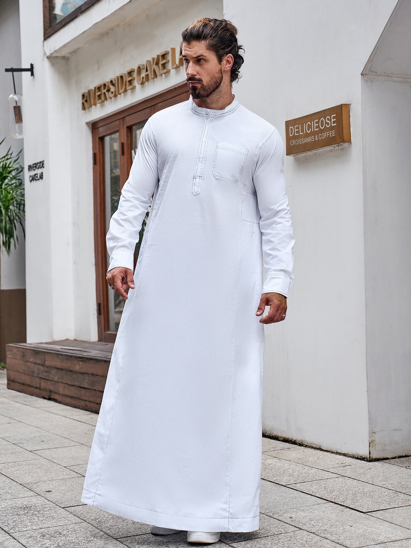 Pure Cotton Saudi White Thobe. This authentic thobe is made from pure cotton fabric and features a standard half collar, long sleeves, chest buttons, and pockets. Shop now at Hikmah Boutique Australia.