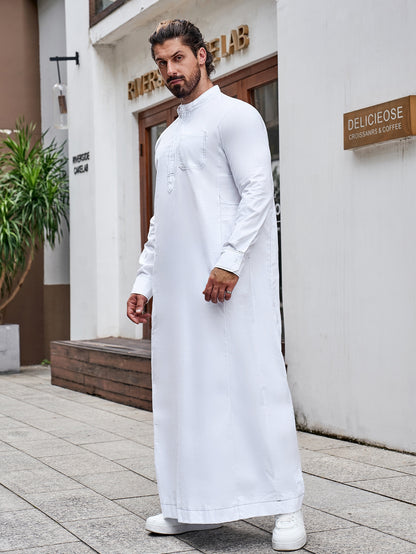 Pure Cotton Saudi White Thobe. This authentic thobe is made from pure cotton fabric and features a standard half collar, long sleeves, chest buttons, and pockets. Shop now at Hikmah Boutique Australia.