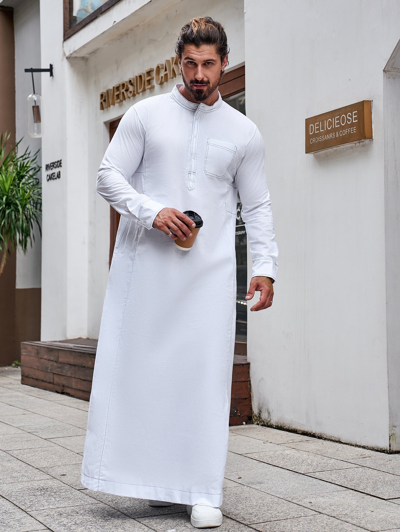 Pure Cotton Saudi White Thobe. This authentic thobe is made from pure cotton fabric and features a standard half collar, long sleeves, chest buttons, and pockets. Shop now at Hikmah Boutique Australia.