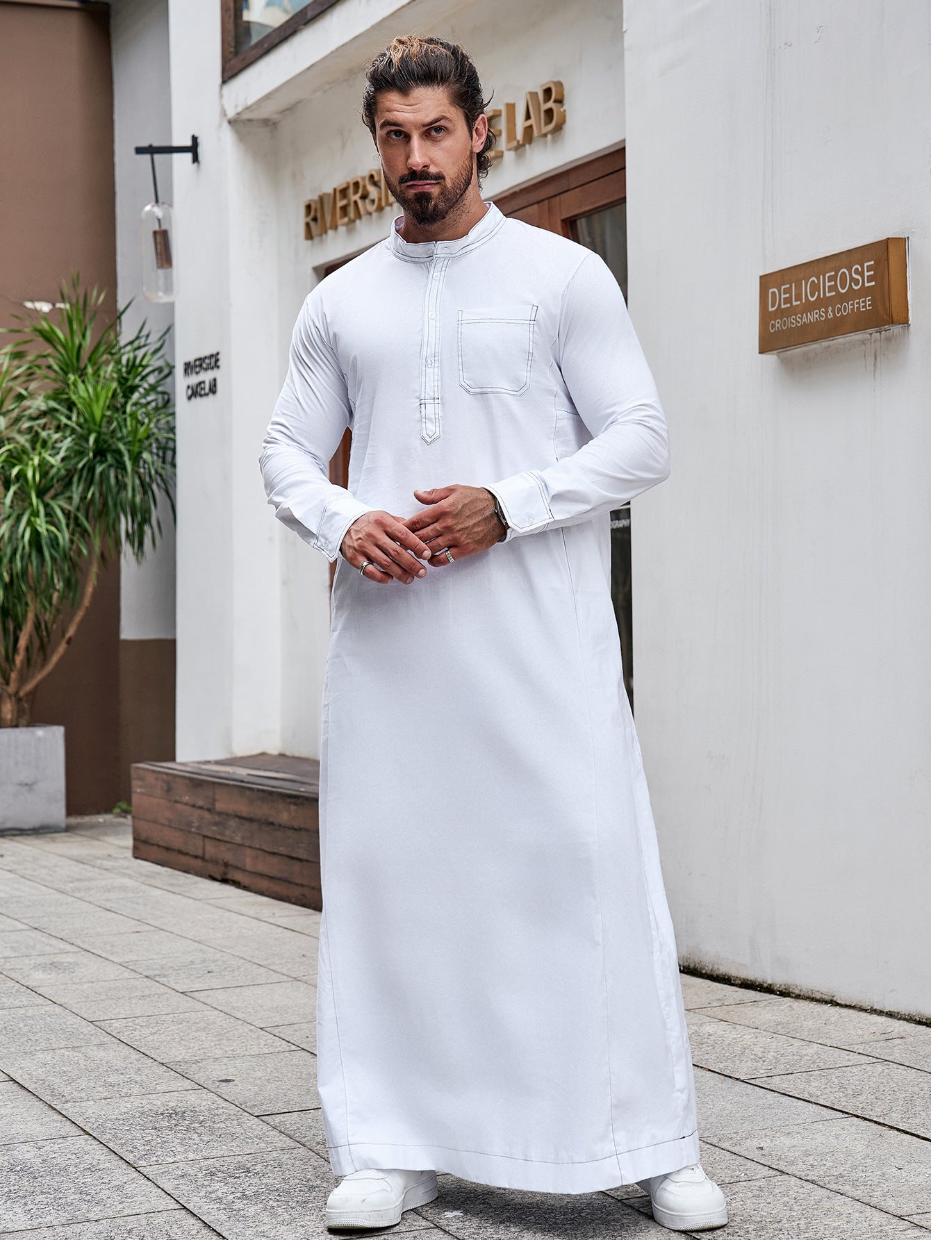 Pure Cotton Saudi White Thobe. This authentic thobe is made from pure cotton fabric and features a standard half collar, long sleeves, chest buttons, and pockets. Shop now at Hikmah Boutique Australia.