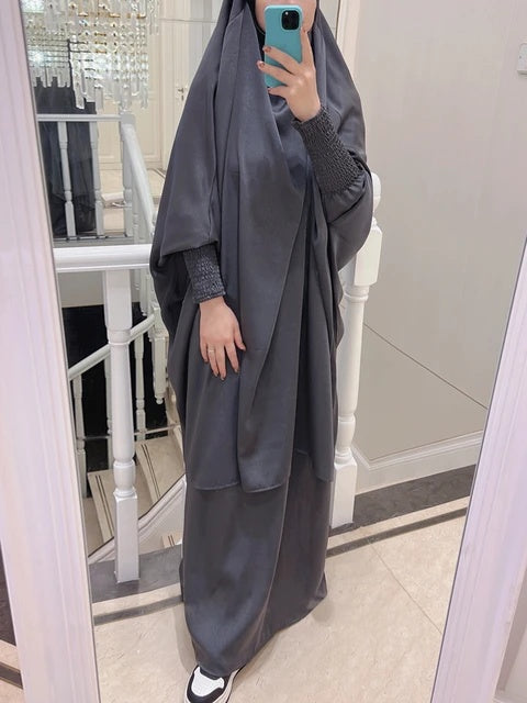 Discover elegance with our Satin French Jilbab in Dark Grey. Exclusively available at Hikmah Boutique, shop online for this two-piece set designed for style and prayer. Free-size and crafted with premium satin material, experience comfort and sophistication. Buy now!