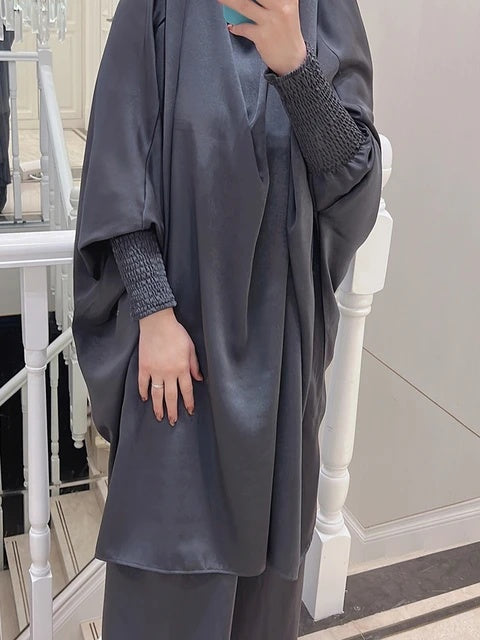 Discover elegance with our Satin French Jilbab in Dark Grey. Exclusively available at Hikmah Boutique, shop online for this two-piece set designed for style and prayer. Free-size and crafted with premium satin material, experience comfort and sophistication. Buy now!