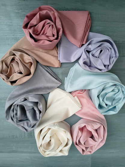 Discover elegance with our Cream Satin Hijab. Crafted from premium satin, exuding sophistication. These Textured Satin Hijabs are Perfect for formal occasions or daily wear. Discover the best satin hijabs online, perfect for special occasions. Premium quality and trendy designs at Hikmah Boutique.