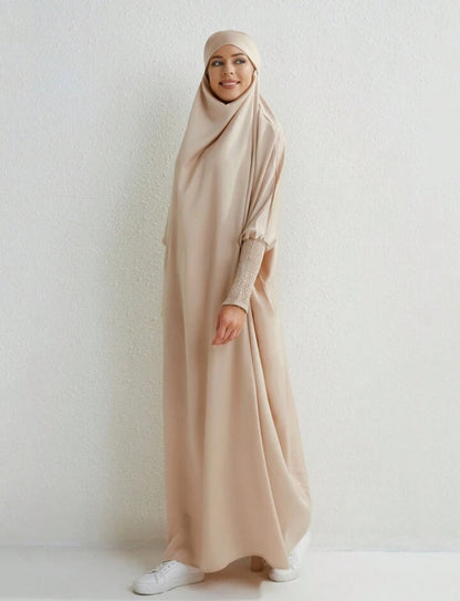Introducing the epitome of refined modesty and timeless sophistication - the Satin Jilbab in Cream Beige, exclusively offered by Hikmah Boutique. Immerse yourself in the luxurious embrace of satin fabric meticulously tailored to perfection, promising an unparalleled experience of grace and elegance. 