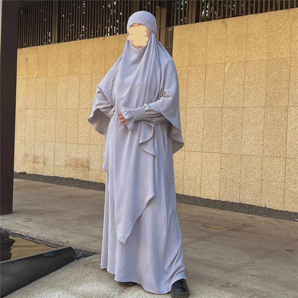 Indulge is an understated elegance of our Silver Grey Crepe Crinkle Abaya with Double Layer Khimar Set, a symbol of modesty and sophistication exclusively available at Hikmah Boutique. The modest design of silver grey offers an ensemble that seamlessly blends tradition and contemporary style with refined grace. 