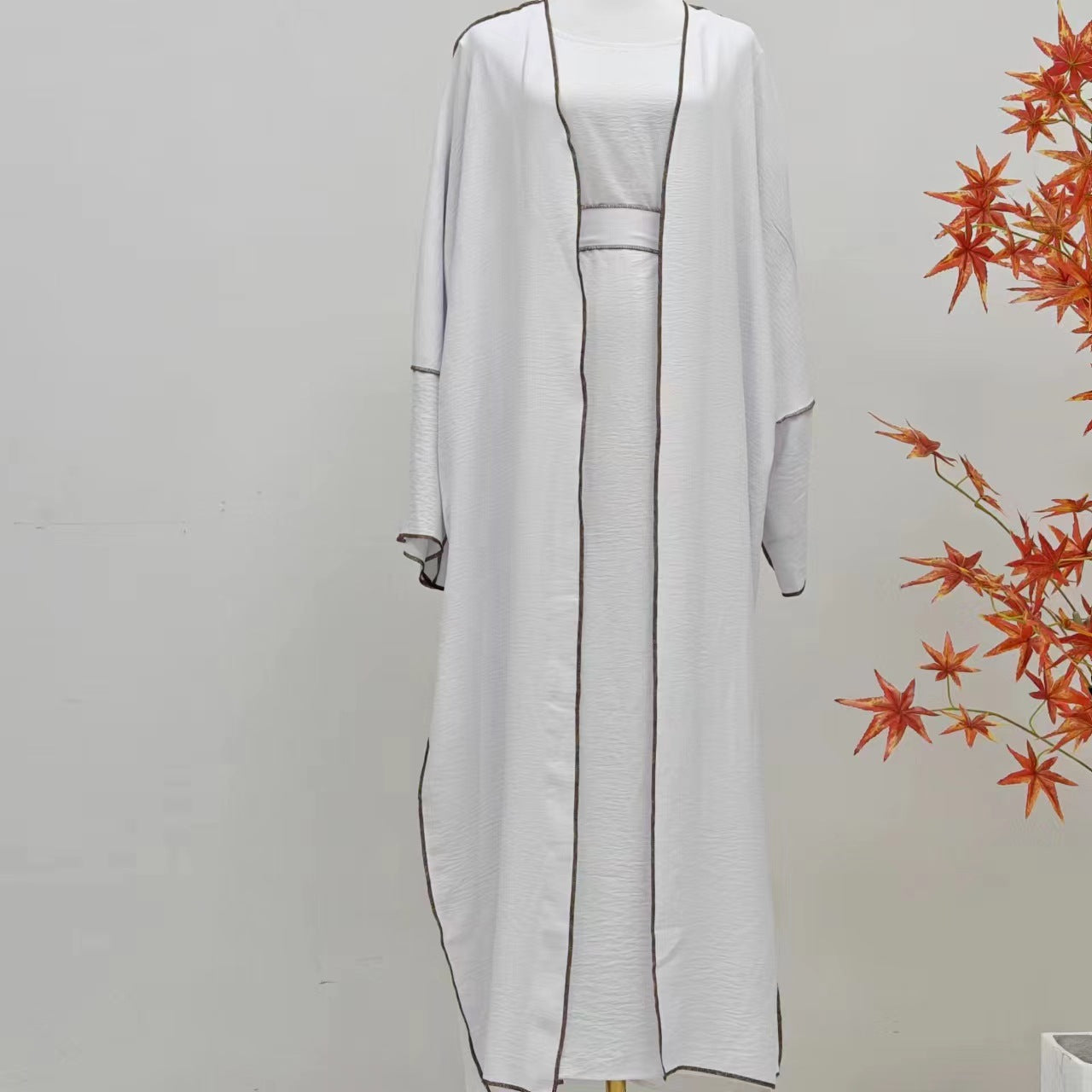 Modest elegance and comfort with Summer Abaya 2-Piece Set in White, exclusively available at Hikmah Boutique. This Modest Abaya set is crafted to keep you cool in Umrah.