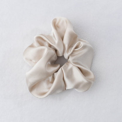 Indulge in the luxurious softness of our 100% silk scrunchies. Our Silk Scrunchies designed to elevate your hair styling routine. Made from the finest quality 100% silk, these scrunchies offer an incredibly gentle and silky-smooth touch that helps minimize hair breakage. Silk Scrunchies keep hair looking pristine.