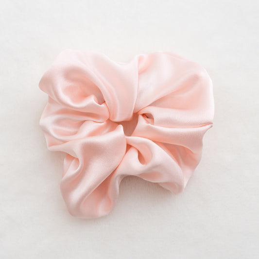 Indulge in the luxurious softness of our 100% silk scrunchies, designed to elevate your hair styling routine. Made from the finest quality 100% silk, these scrunchies offer an incredibly gentle and silky-smooth touch that helps minimize hair breakage and keep your tresses looking pristine. Available in 3.5cm & 6cm.