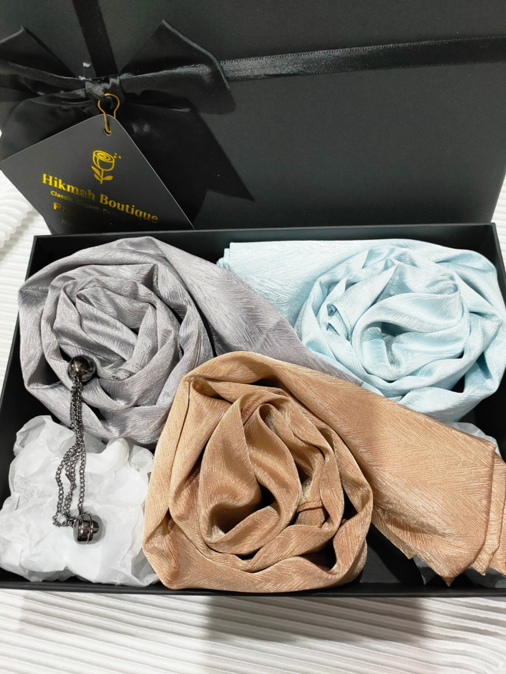 Textured Satin Gift Box with Magnetic Hijab Pins, a luxurious and stylish choice for enhancing your hijab experience or gifting to a loved one. This meticulously curated gift box combines elegance, functionality, and convenience, offering a complete package to elevate your hijab styling. Buy now at Hikmah Boutique.