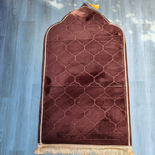 Introducing the exquisite brown color prayer mat designed by Hikmah Boutique, a true testament to craftsmanship, comfort, and style. Experience the ultimate comfort, crafted with premium materials, it offers unparalleled softness for your daily prayers, all at an affordable price.